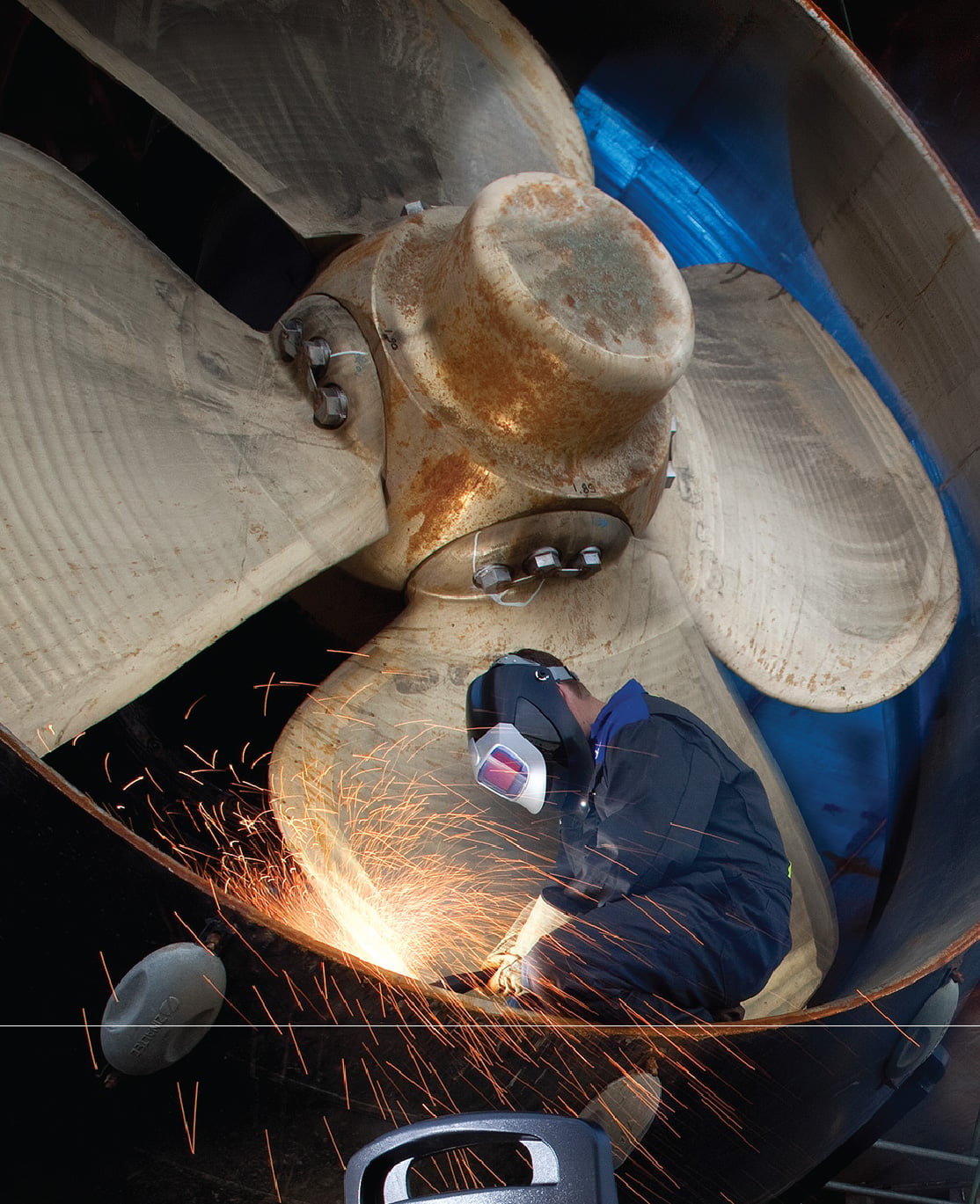 cutting metal on ship propeller
