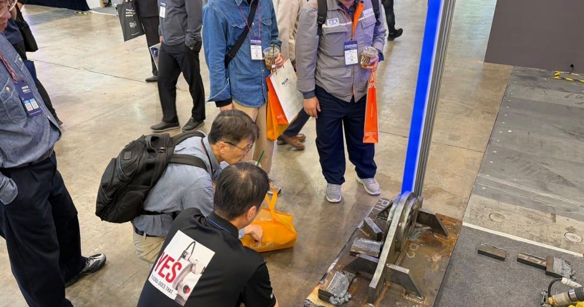 Image of men around a machine